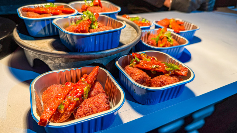Tater tots and spam "fries" plated in tin containers