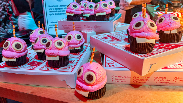 Pink cupcakes decorated with large teeth and googly eyes