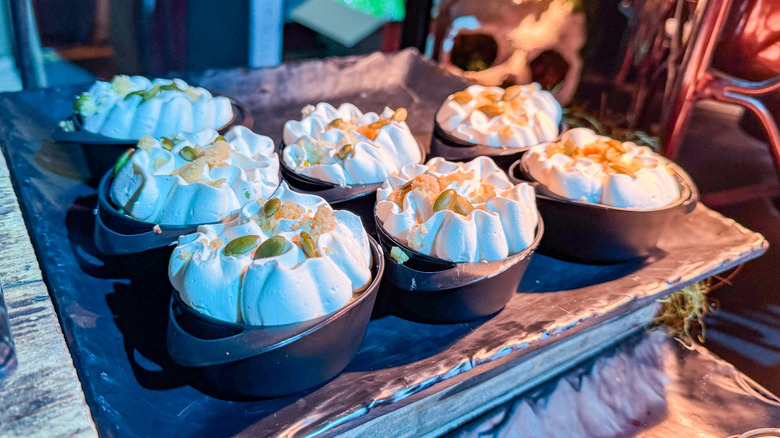 Small black pots of vegan pumpkin mousse