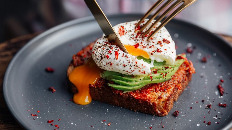 Poached runny egg on avocado toast