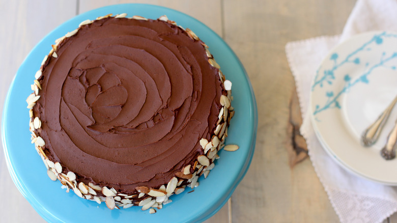 Queen of Sheba cake on a blue plate garnished with shaved almonds