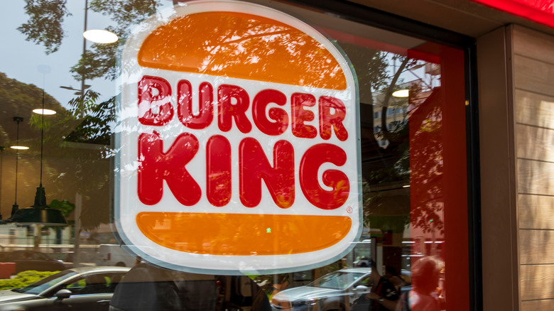 Glass reflection of exterior against BK sign