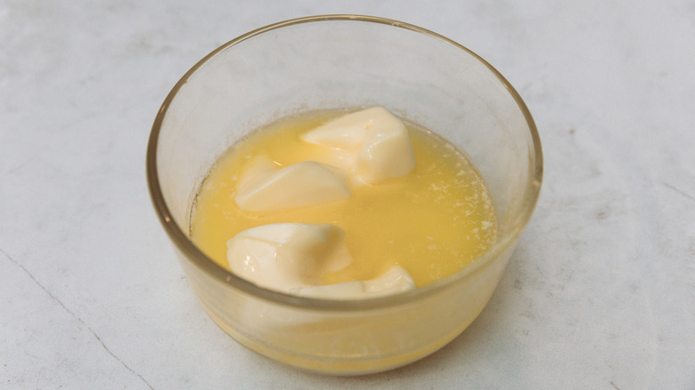 Partially melted butter in a glass ramekin