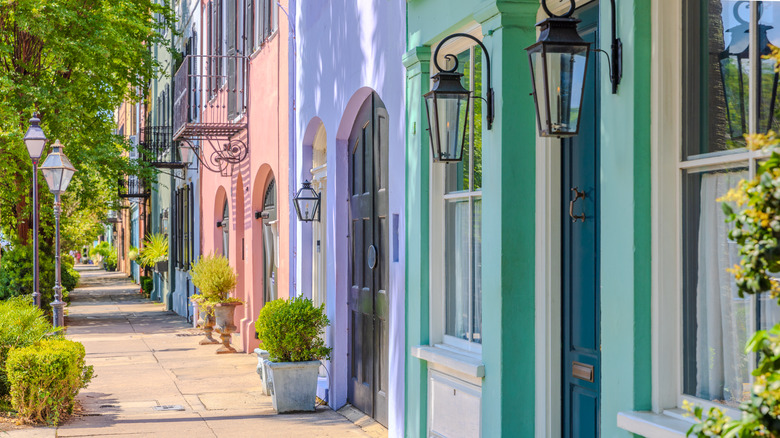 pastel doorways in buildings viewed along a sidewalk in Charleston