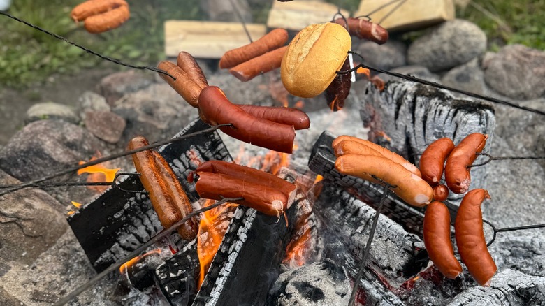 Sausages on sticks over a fire