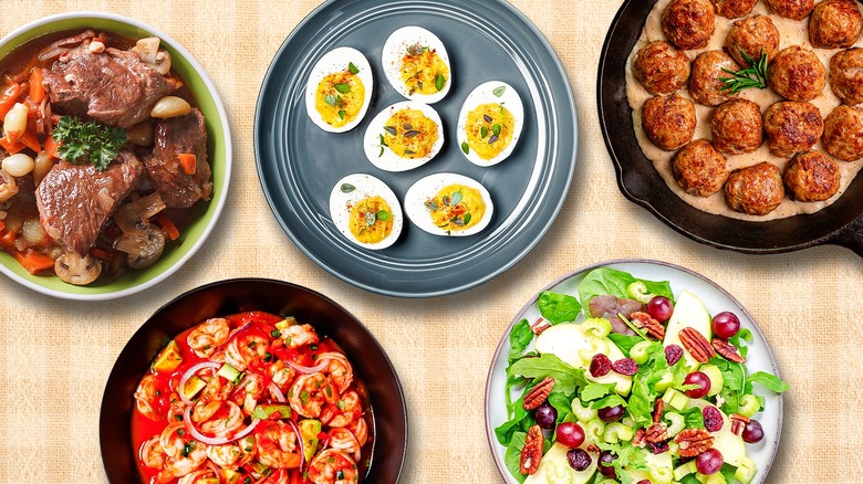 Buffet foods including deviled eggs, Swedish meatballs, beef Burgundy, Waldorf salad, and shrimp cocktail