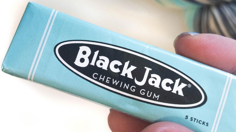 Hand holding Black Jack gum