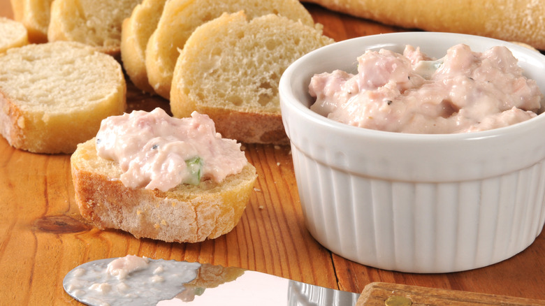 A white ramiken of ham salad with slices of sourdough