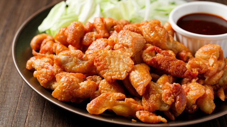 Fried chicken skin crackers on a brown plate