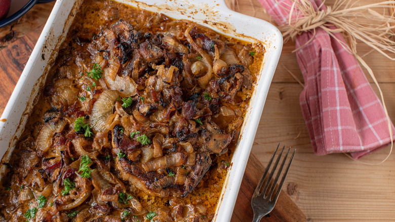A pork casserole in a baking dish on a table