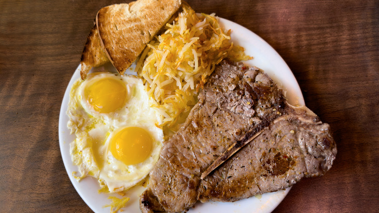 Steak and eggs with toast and hash browns
