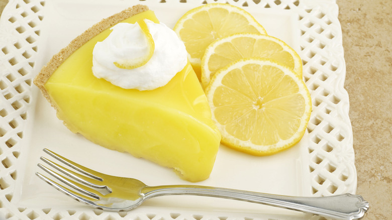 Slice of lemon icebox pie on white plate