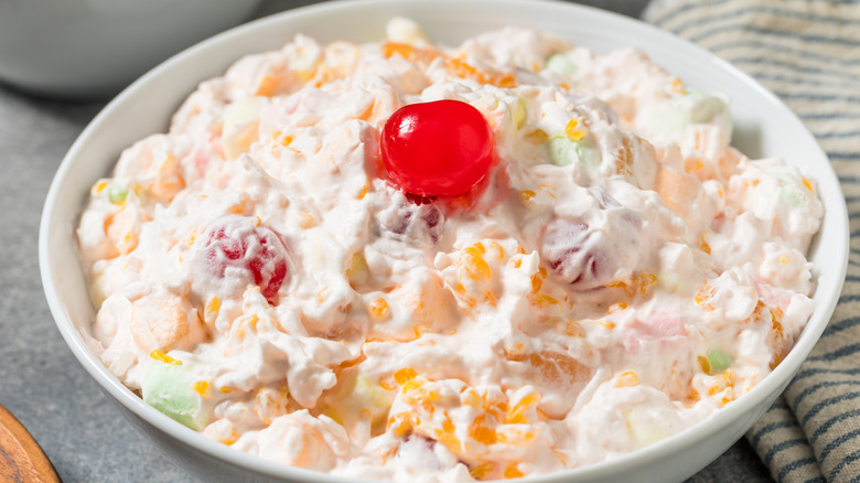 Bowl of ambrosia salad with cherry on top