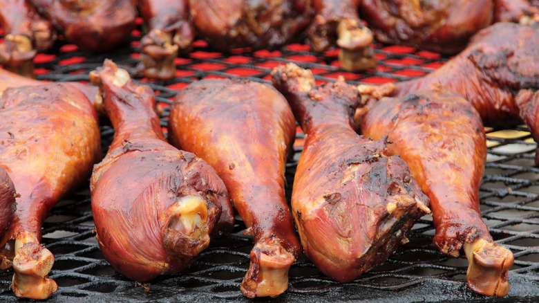 Giant turkey legs on a grill at a county fair