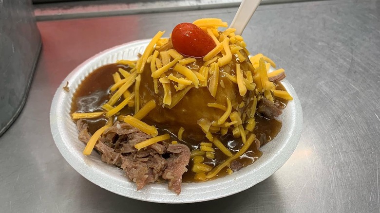 A hot beef sundae on a metal counter