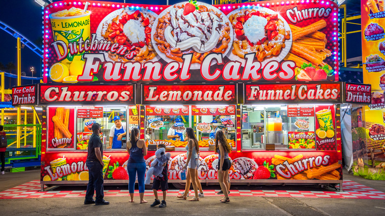 People ordering food at a state fair food stand