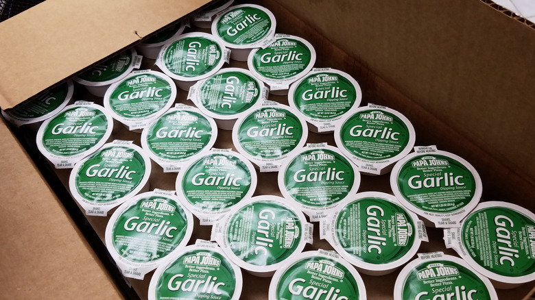 Box full of Papa John's garlic dipping sauce cups