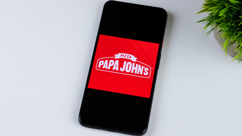 Smartphone with Papa John's logo on screen