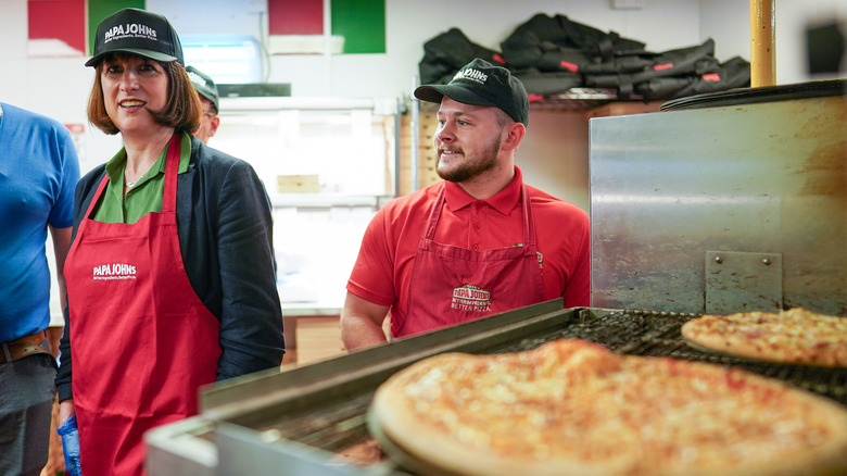 Staff members working inside Papa John's store