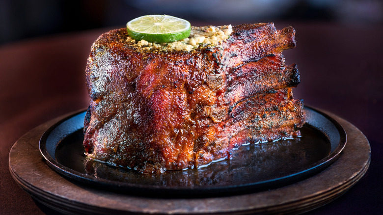 A Perry's Famous Pork Chop on a cast iron plate at Perry's Steakhouse & Grille