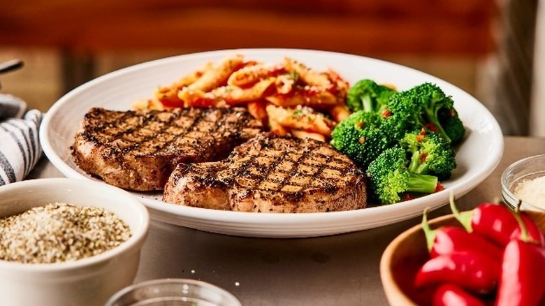 A plate of pork chops with vegetables at Carrabba's Italian Grill