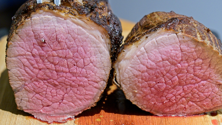 Smoked and grilled beef round steak cut in half