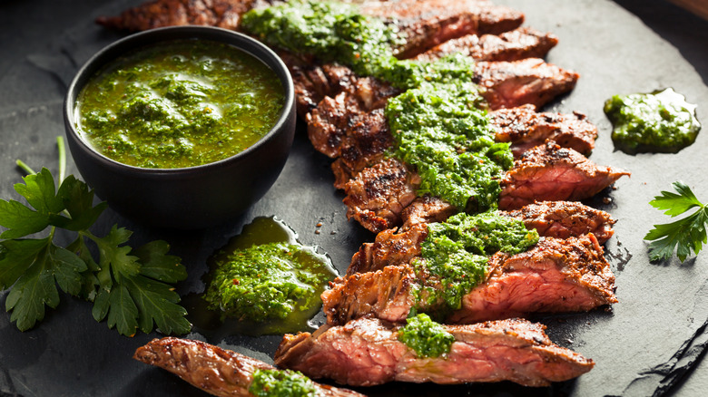 Grilled sliced skirt steak with chimichurri sauce