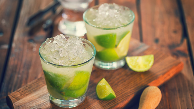 Two cocktails with lime wedges