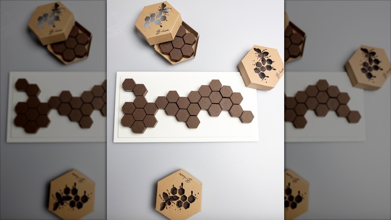 Chocolate confections in a geometric pattern and in gold boxes
