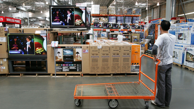 A person shopping for electronics at Costco