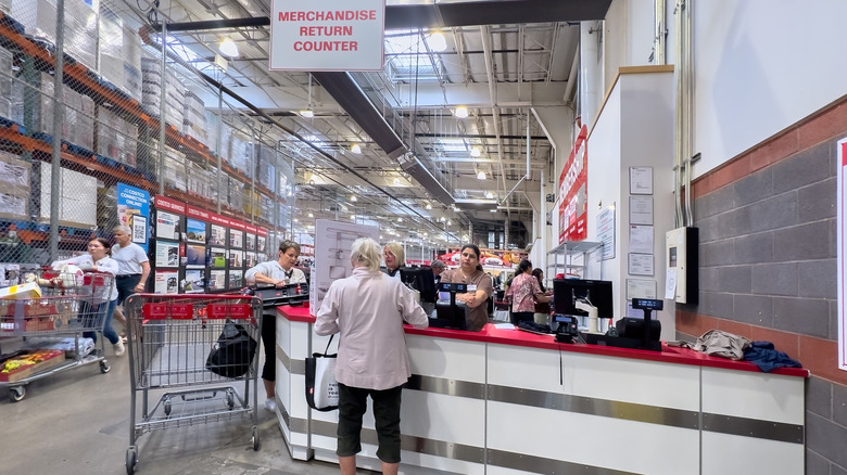 A person standing at the returns counter of a Costco