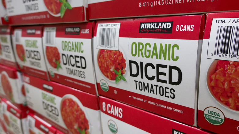 Boxes of Kirkland Siganature Organic siced tomatoes at a Costco warehouse