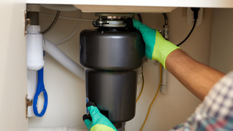 Man installing a garbage disposal