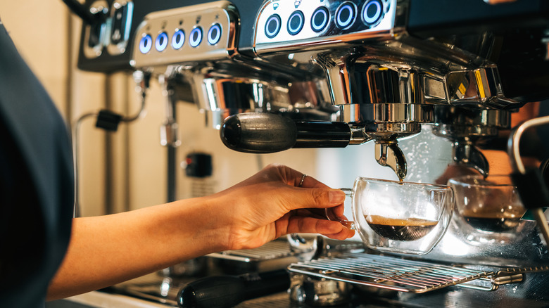Person pulling a shot from an espresso machine