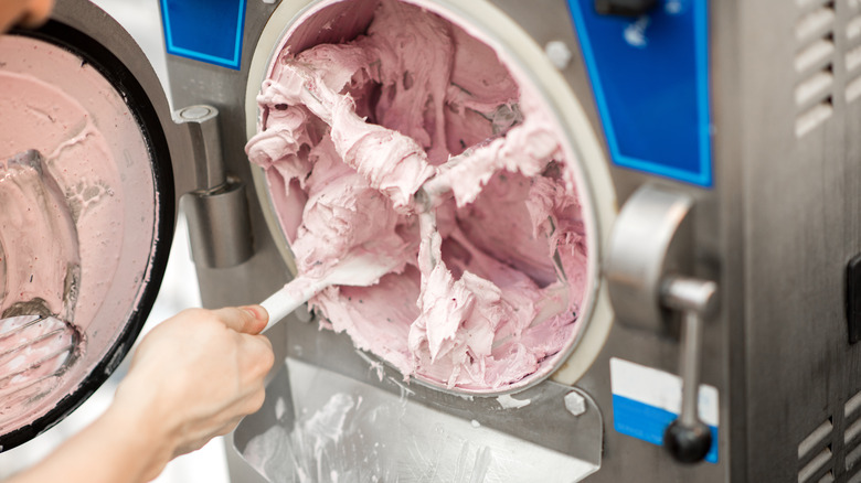 Person opening an ice cream machine