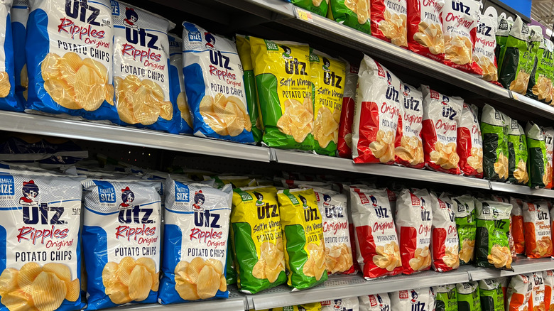 Grocery store shelves lined with various flavors of Utz Potato Chips