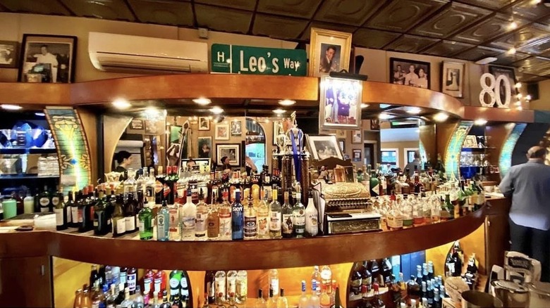 Fisheye shot of Leo's bar, with street sign and vintage cash register