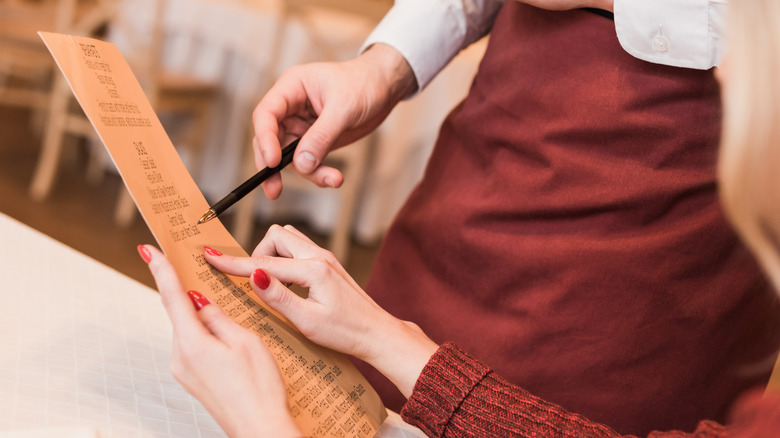 Customer ordering food from menu