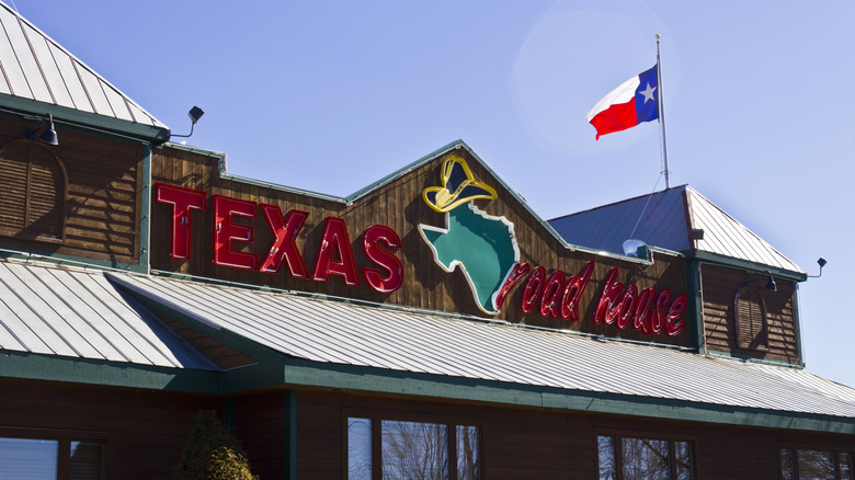 Texas Roadhouse exterior sign and Texas flag