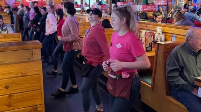 Texas Roadhouse "Roadies" employees line dancing in the restaurant