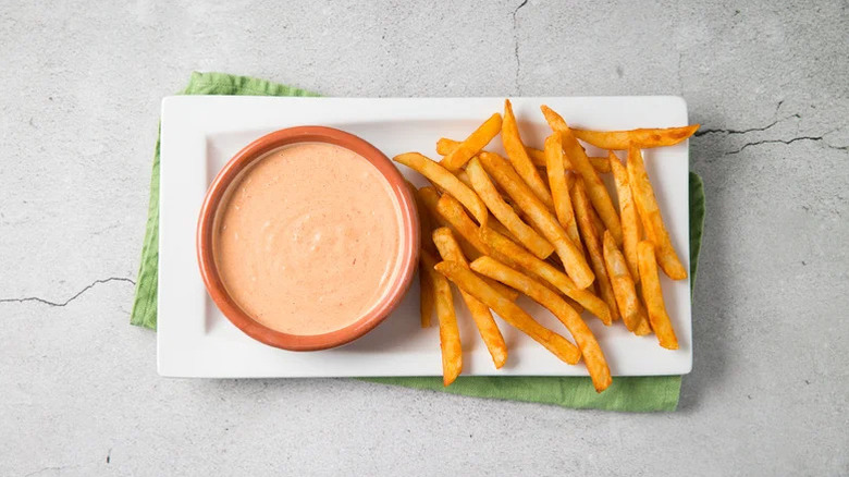 Bowl of chipotle mayo with fries