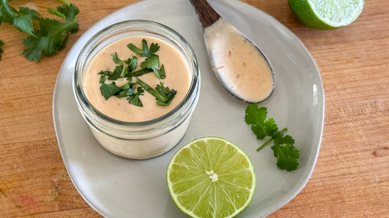 Chipotle crema on a plate with a lime