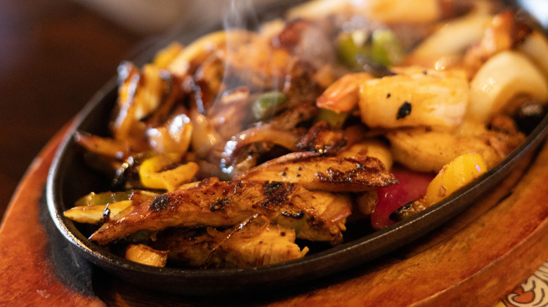 A skillet of chicken, onion, and pepper fajitas