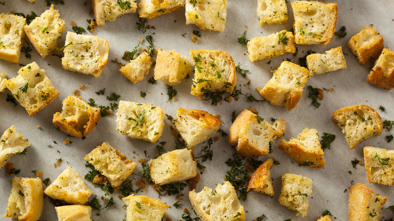 Baking sheet of homemade croutons seasoned with herbs