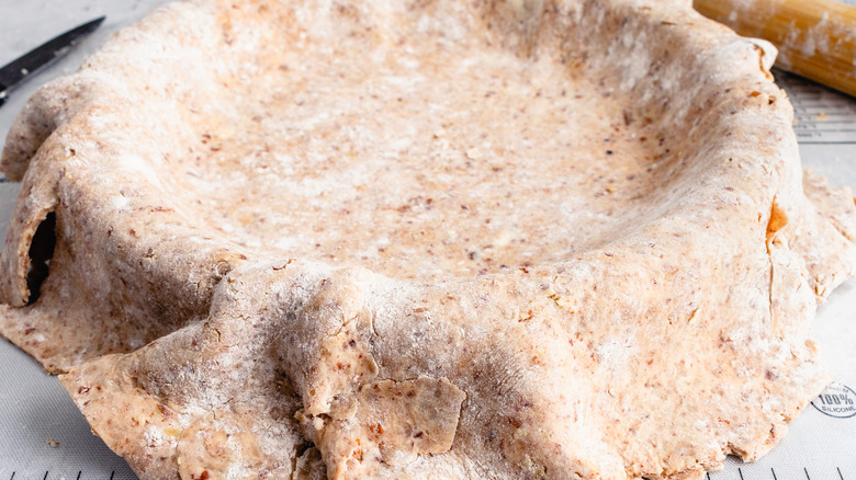 Peacan pie crust on a wooden surface
