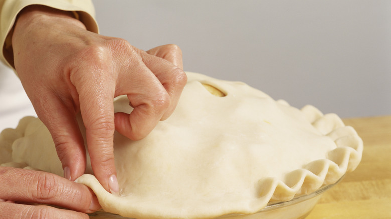 Person crimping pie crust