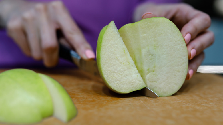 Apples slicing on cutting board