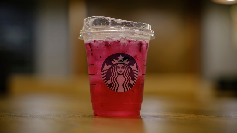 A Starbucks refresher sits on a table.
