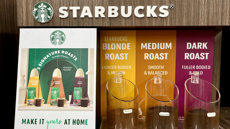 A Starbucks display features blonde, medium, and dark roasts.