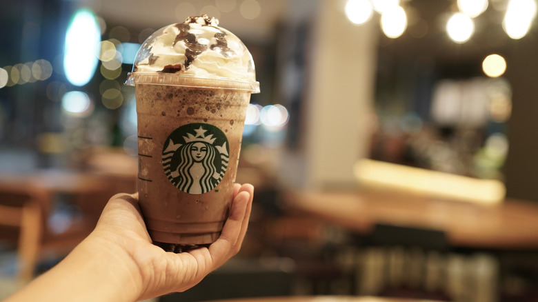 A Starbucks customer holds a Java Chip Frappuccino.